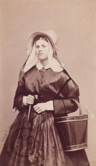 Belgian girl with umbrella and bucket