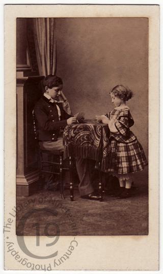 Two children playing cards