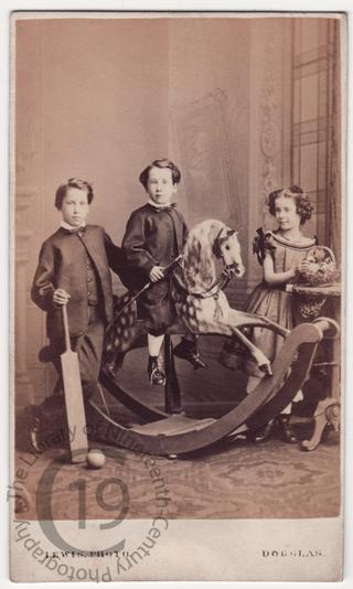 Three children with a rocking horse