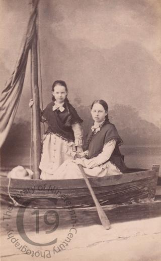 Two girls in a fake rowing boat