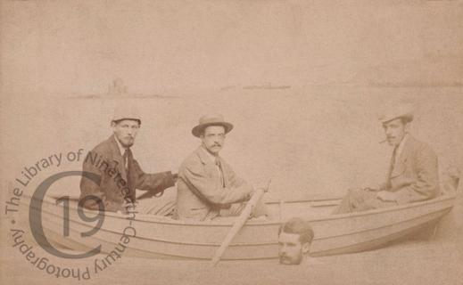 Three men in a fake rowing boat