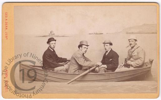 Four men in a fake rowing boat