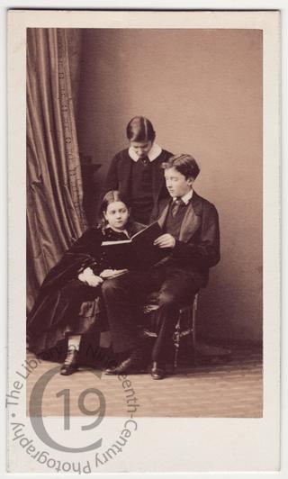 Three children with a book