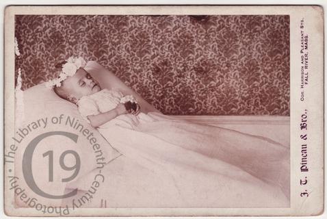 Infant with wreath of white flowers